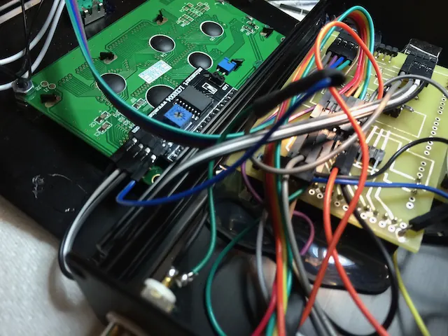 A circuit board wired up with rainbow jumper wires