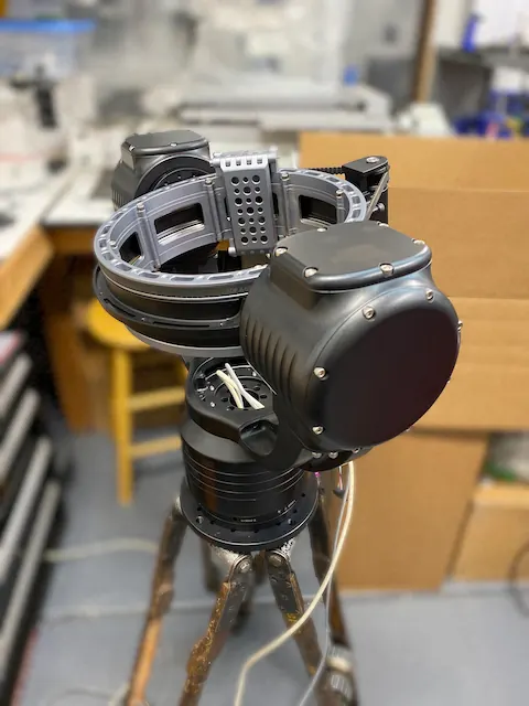 A camera rig on a gimbal mount on a tripod