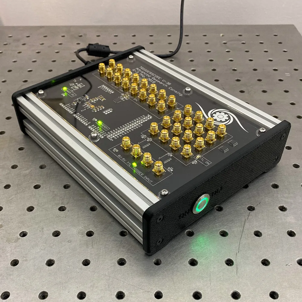 Triggerscope 3B on an optical breadboard with a green power LED